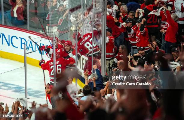 The Carolina Hurricanes celebrate after a 3-2 victory in overtime against the New Jersey Devils in Game Five of the Second Round of the 2023 Stanley...