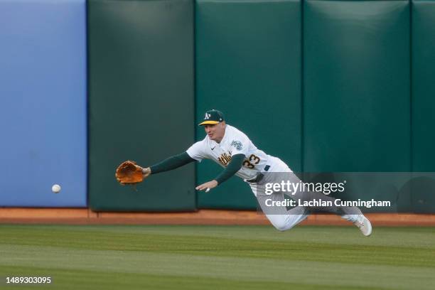 Bleday of the Oakland Athletics is unable to catch a fly ball hit by Nathaniel Lowe of the Texas Rangers in the top of the fourth inning at...