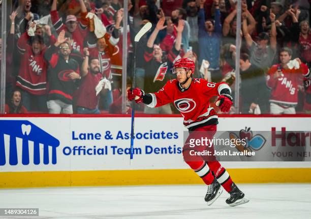 Jesperi Kotkaniemi of the Carolina Hurricanes celebrates after the game-winning goal by Jesper Fast in overtime to defeat the New Jersey Devils in...