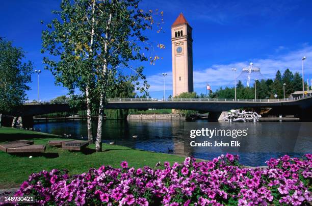 a view of the clock tower in riverfront park from across the spokane river. - spokane ストックフォトと画像