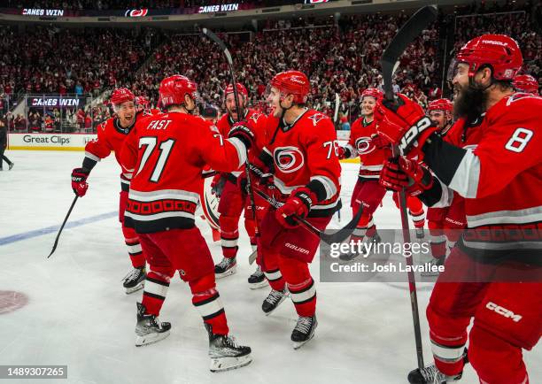 The Carolina Hurricanes celebrate with the storm surge after defeating the New Jersey Devils in Game Five of the Second Round of the 2023 Stanley Cup...