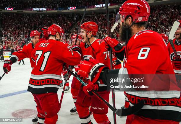 The Carolina Hurricanes celebrate with the storm surge after defeating the New Jersey Devils in Game Five of the Second Round of the 2023 Stanley Cup...