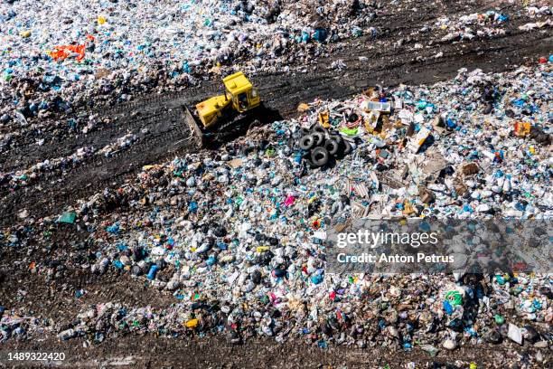 aerial view of bulldozer at city dump. the concept of pollution - plastic stock pictures, royalty-free photos & images