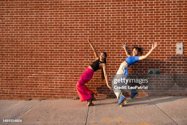 two friends with roller skates - friends roller skating stock pictures, royalty-free photos & images