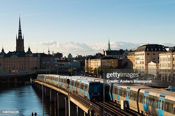 commuter trains crossing centralbron. - centralbron stock pictures, royalty-free photos & images