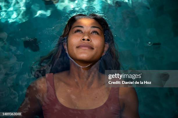 top view of woman relaxing in the swimming pool. vacation - schönheit frau wasser gesicht stock-fotos und bilder