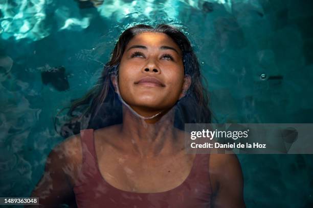 top view of woman relaxing in the swimming pool. vacation - beautiful filipina stock pictures, royalty-free photos & images