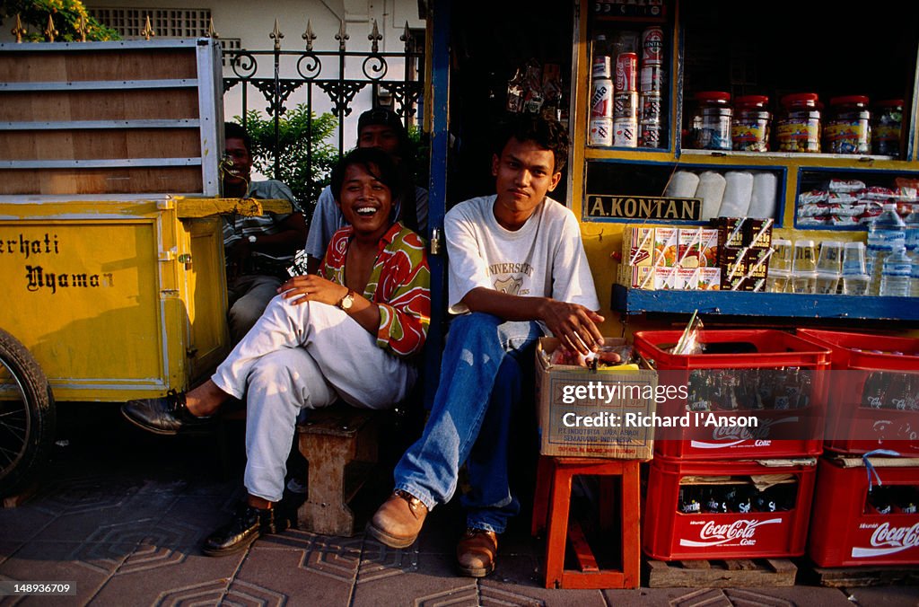 Young men at street stall.