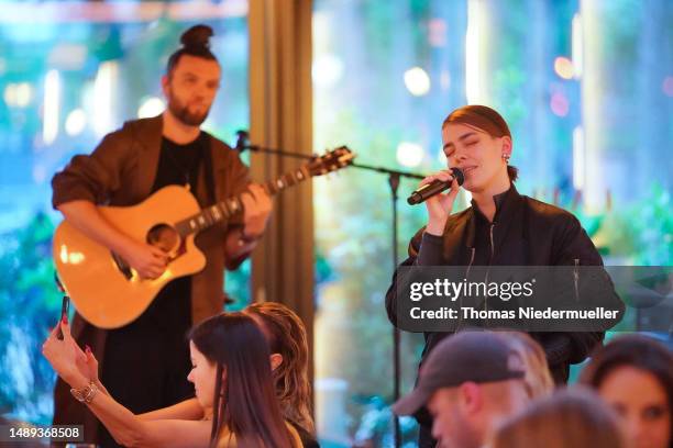 Alina Süggeler and Andi Weizel of Frida Gold perform at the .comTogether Girlbosses event by .comTessa on at La Plage Parisienne May 11, 2023 in...