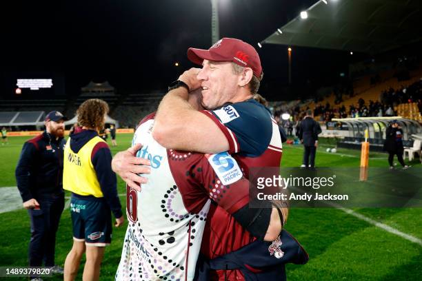 Liam Wright of the Reds celebrates with head coach Brad Thorn after winning the round 12 Super Rugby Pacific match between Chiefs and Queensland Reds...