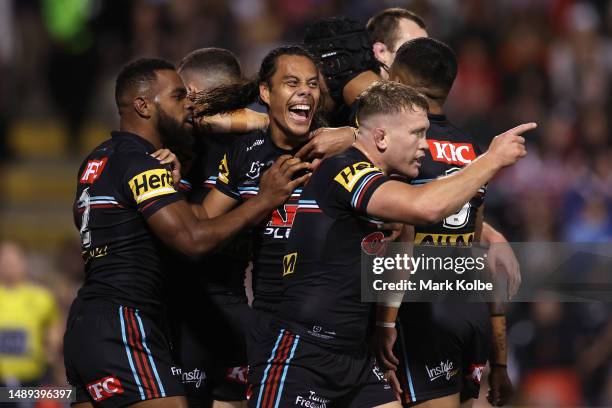 Scott Sorensen of the Panthers celebrates with team mates after scoring a try during the round 11 NRL match between the Penrith Panthers and Sydney...