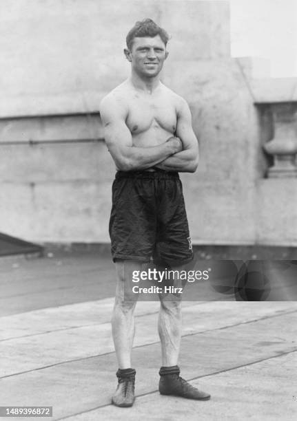British boxer Joe Fox, his arms folded as he poses bare-chested in black boxing shorts, after his first fight in Australia, March 1924. Fox, who...