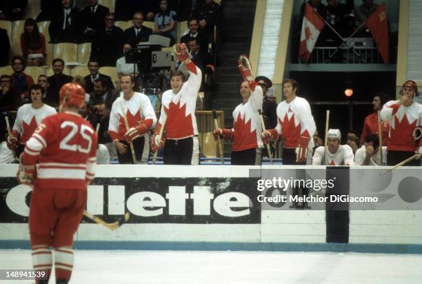 Rod Gilbert, Bill White, Pete Mahovlich, Dennis Hull, Jean Ratelle, Red Berenson and Paul Henderson of Canada look on from the bench during their...