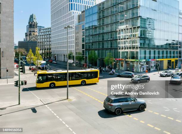 a view from above of a busy street in berlin's mitte district, with the kaiser-wilhelm-gedächtniskirche in the background. - berlin aerial stock pictures, royalty-free photos & images