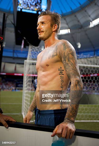 David Beckham of the Los Angeles Galaxy stands bare chested after the MLS game against the Vancouver Whitecaps FC July 18, 2012 at BC Place in...