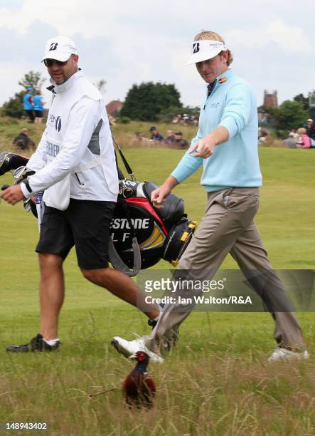 Brandt Snedeker of the United States points at a pheasant on the sixth hole alongside caddie Scott Vail during the second round of the 141st Open...