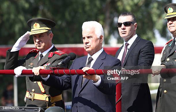 Turkish Cypriot leader Dervis Eroglu attend a military parade marking the 38th anniversary of the Turkish military invasion of Cyprus, on July 20,...