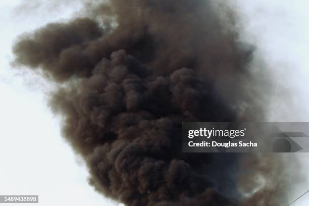 thick black smoke from a massive burning fire - thick stock pictures, royalty-free photos & images