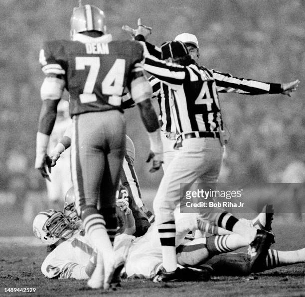 Miami Dolphins QB Dan Marino under heavy pressure and gets sacked for a loss from San Franciscos Jeff Stover , Dwaine Board and Gary Johnson during...