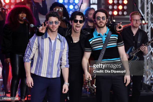 Nick Jonas, Joe Jonas, and Kevin Jonas of the Jonas Brothers pose as they perform on NBC's "Today" at Rockefeller Plaza on May 12, 2023 in New York...