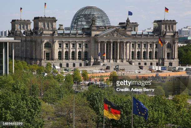 The Reichstag, the seat of the German federal parliament, or Bundestag, is seen as German and European Union flags fly, on May 12, 2023 in Berlin,...