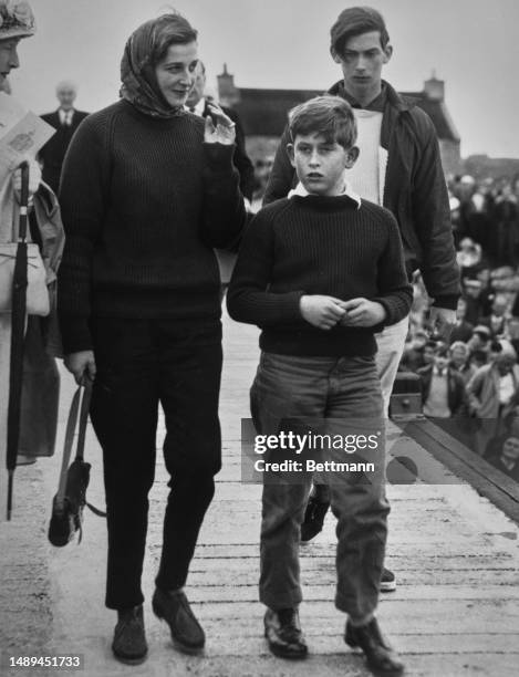 Prince Charles , Princess Alexandra and Prince Michael of Kent walk along the pier at Lerwick as they return to the royal yacht Britannia during...