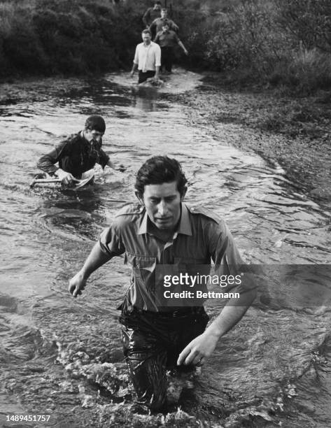 Prince Charles wades through a stream during a commando training session at the Royal Marines training centre at Lympstone in Devon, January 13th...