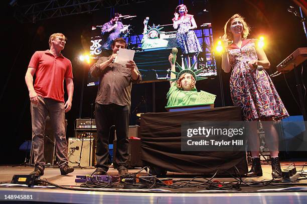 Comedienne Kristen Schaal receives a cake with her face as the Statue of Liberty before she moves to Los Angeles after she performs during the 2012...