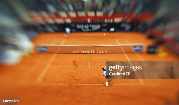 This picture made using a Lensbaby selective focus lens shows French tennis player Jérémy Chardy who eyes the ball to hit return during the...