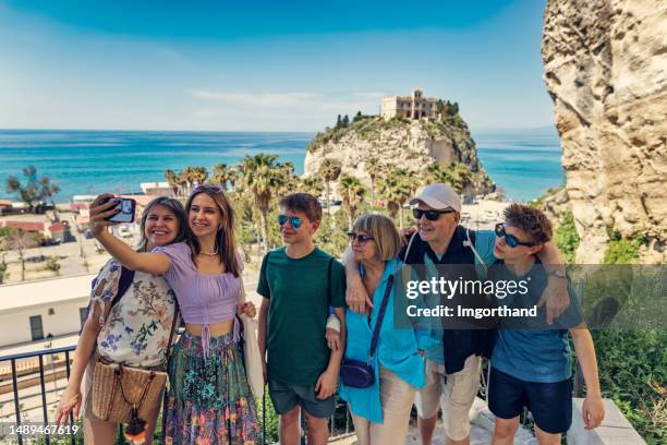 multi generation family sightseeing beautiful calabrian town of tropea - happy smiling people multi generations stock pictures, royalty-free photos & images