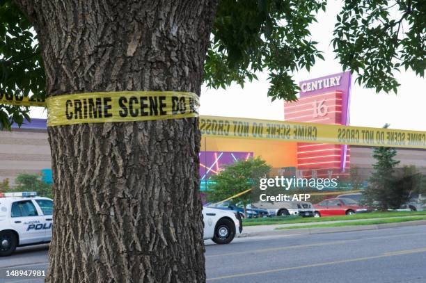 Police cars in front of the Century 16 theater in Aurora, Colorado where a gunman opened fire during the opening of the new Batman movie "The Dark...