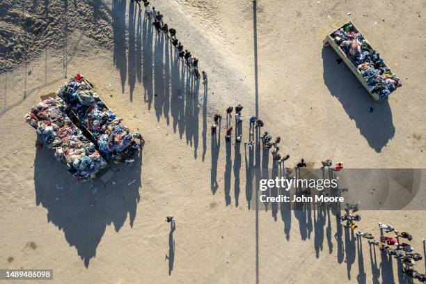 As seen from an aerial view, immigrants line up to be processed by U.S. Border Patrol agents at the U.S.-Mexico border on May 12, 2023 in El Paso,...