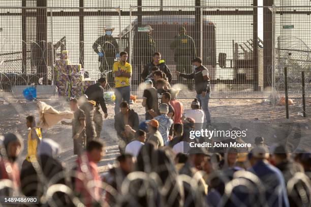 Immigrants wait to be transported and processed by U.S. Border Patrol agents at the U.S.-Mexico border on May 12, 2023 in El Paso, Texas. The U.S....