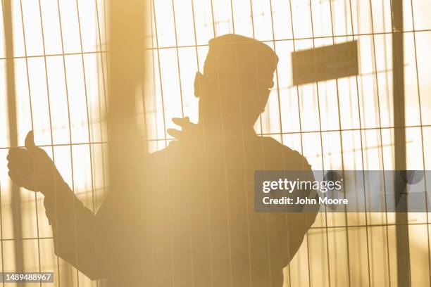 Texas National Guard Soldier mans the perimeter of a makeshift migrant encampment at the U.S.-Mexico border on May 12, 2023 in El Paso, Texas. The...