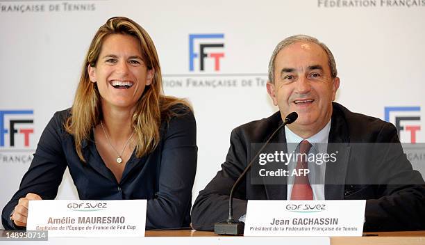 Former world number one Amelie Mauresmo smiles during a press conference next to the president of the French Tennis Federation , Jean Gachassin, on...