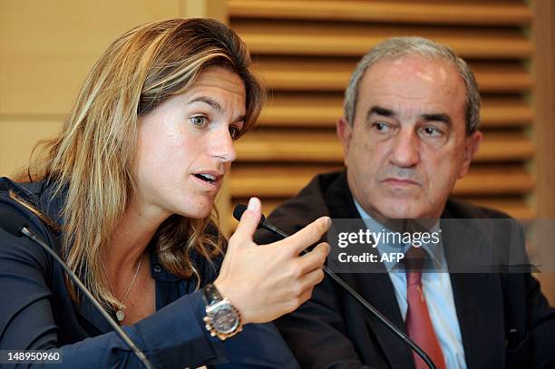 Former world number one Amelie Mauresmo speaks during a press conference next to the president of the French Tennis Federation , Jean Gachassin, on...