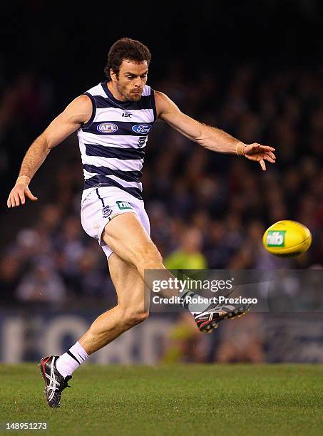 Matthew Scarlett of the Cats kicks during the round 17 AFL match between the Geelong Cats and Essendon Bombers at Etihad Stadium on July 20, 2012 in...