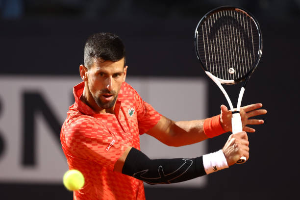 Novak Djokovic of Serbia plays a backhand in the men's singles second round against Tomas Martin Etcheverry of Argentina during day five of the...
