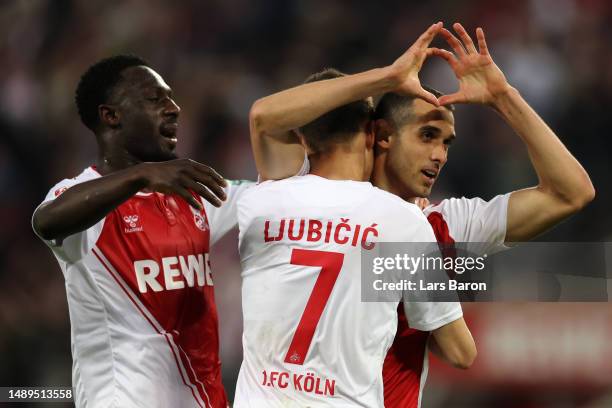 Ellyes Skhiri of FC Koln celebrates scoring his teams third goal of the game with teammates Dejan Ljubicic and Kingsley Schindler during the...