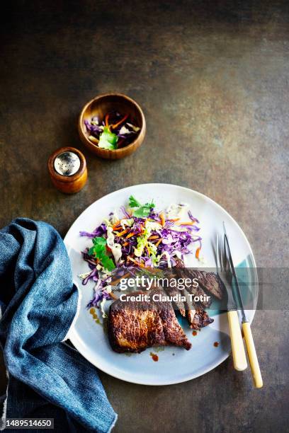 plate of steak with fresh salad on rusty, brown background - beefsteak 2013 stock pictures, royalty-free photos & images