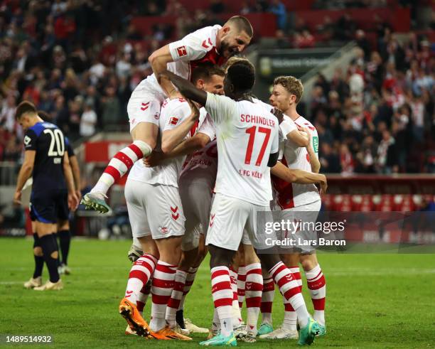 Ellyes Skhiri of FC Koln celebrates scoring his teams third goal of the game with teammates Dejan Ljubicic and Kingsley Schindler during the...