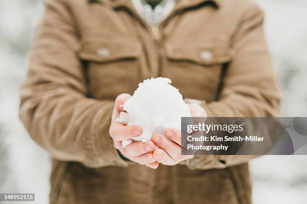 boy holding snowball - mid section stock pictures, royalty-free photos & images