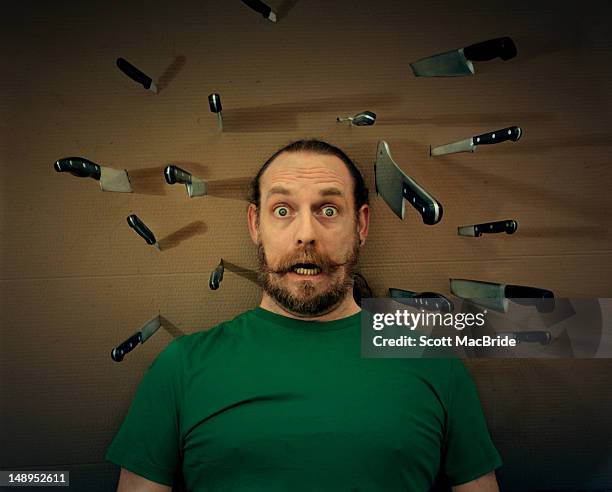 man with knifes stuck - scott macbride stock pictures, royalty-free photos & images