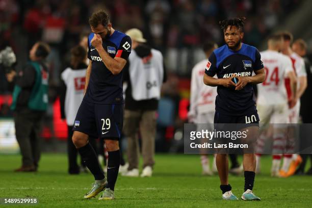 Lucas Tousart and Chidera Ejuke of Hertha BSC look dejected after defeat in the Bundesliga match between 1. FC Köln and Hertha BSC at...