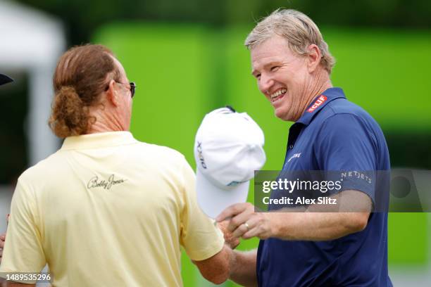 Ernie Els of South Africa celebrates with Miguel Angel Jimenez of Spain after their round on the 18th green during the second round of the Regions...