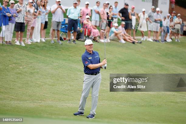 Ernie Els of South Africa chips onto the 18th green during the second round of the Regions Tradition at Greystone Golf and Country Club on May 12,...