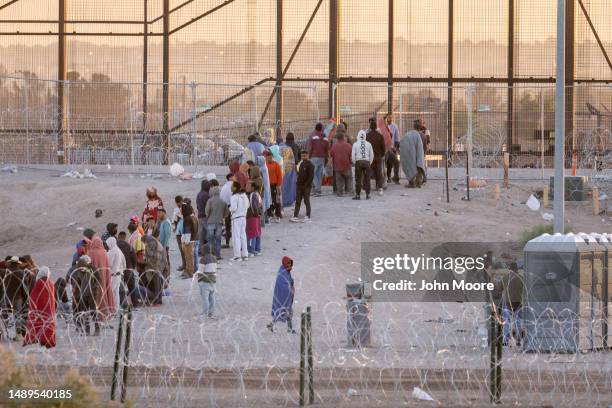 Immigrants wait to be transported and processed by U.S. Border Patrol officers at the U.S.-Mexico border on May 12, 2023 in El Paso, Texas. The U.S....
