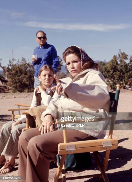 American country music singer Carlene Carter and her mother singer, songwriter and dancer June Carter Cash sit outside in Tucson, Arizona, circa 1970.
