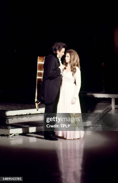 American country singer Johnny Cash and his wife, singer, songwriter and dancer June Carter Cash perform on stage during an episode of The Johnny...