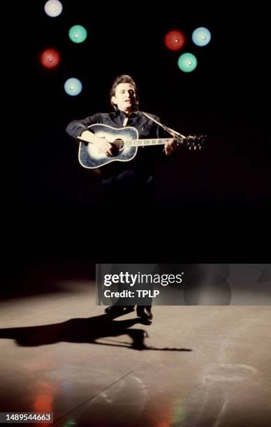 American country singer Johnny Cash sings and plays his guitar on stage during The Johnny Cash Show in Tucson, Arizona, April 15, 1970.